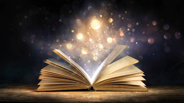 magic book with lights glowing in black background literature