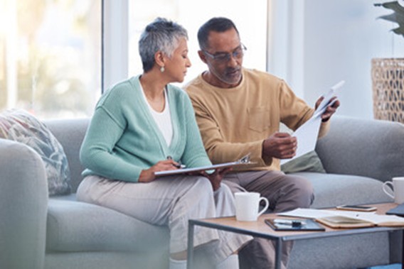 : Older couple reviewing documents as they make plans for the future: Griffin Cornerstone Advisors