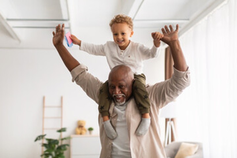 Older gentleman with his grandchild on his shoulders enjoying time together: Griffin Cornerstone Advisors